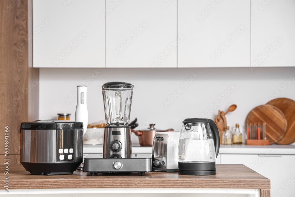Set of appliances on wooden table in contemporary kitchen Set of appliances on wooden table in contemporary kitchen