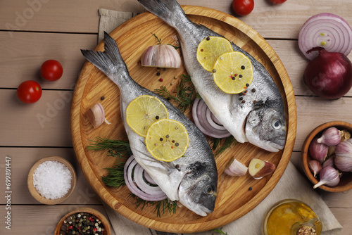 Flat lay composition with raw dorado fish on wooden table