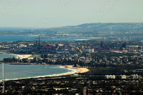 distant view of cityscape with skyscrapers  beaches and industrial steelworks in wollongong  south coast  nsw