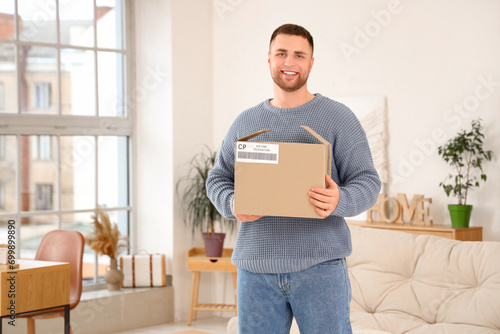 Young man with open parcel ...