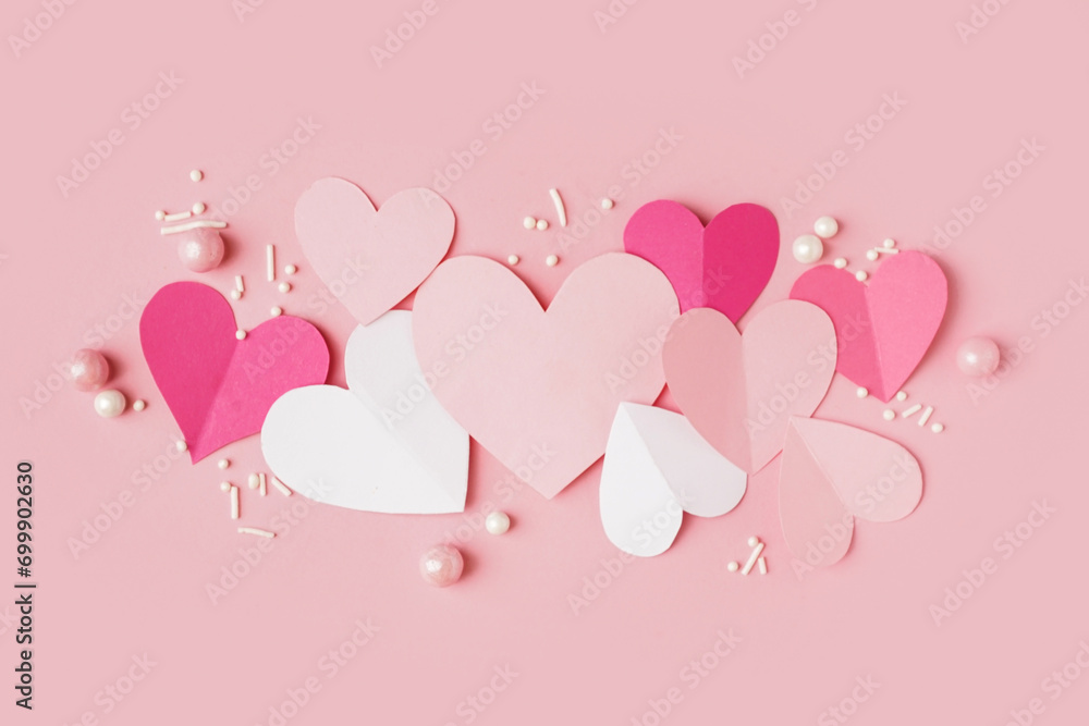 Paper hearts with decor on pink background. Valentine's Day celebration