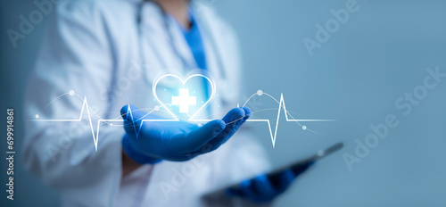Medical worker holding  virtual screen interface heart rate. Health care with medical network connection. People health care awareness rising growth of medical health and life insurance business. photo