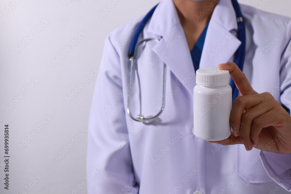 Close up of the ears of a professional female doctor in uniform taking notes in a notebook Medical therapist filling out medical documents. Clipboard. Patient form. Illness history, prescription
