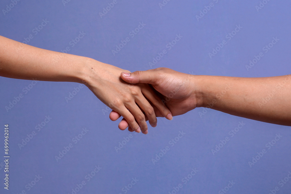 Close up of lovely couple holding hands on gray background
