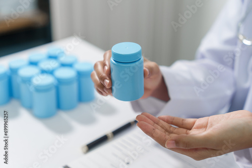 Specialist medical professionals check the quality and expiration date of the vials and medicine capsules.