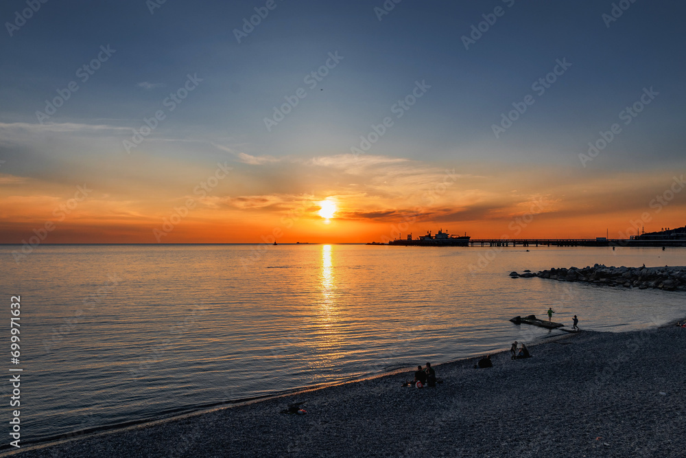 An impressive colorful sunset sky over the Black Sea. Natural background with clouds. Sunset view over the calm sea. Dramatic magical seascape at sunset in the Black Sea.