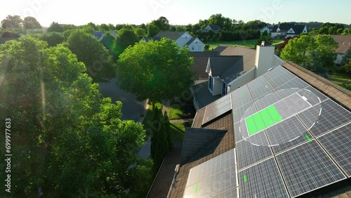 Solar panel with charging battery animation during bright sunset. 3D render on aerial shot of photovoltaic array on American residential rooftop. Renewable, green energy in futuristic neighborhood. photo