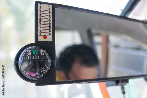 rearview mirror with built-in manual compass in the car photo