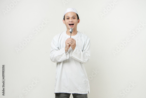 muslim man holding spoon. People religious Islam lifestyle concept. celebration Ramadan and ied Mubarak. on isolated background.