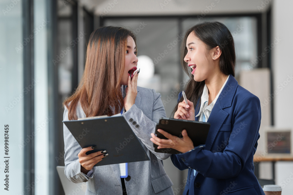 Two Asian businesswomen working together, meeting and discuss of new business project, professional people. Two Asian businesswomen working together, meeting and discuss of new business project, professional people.