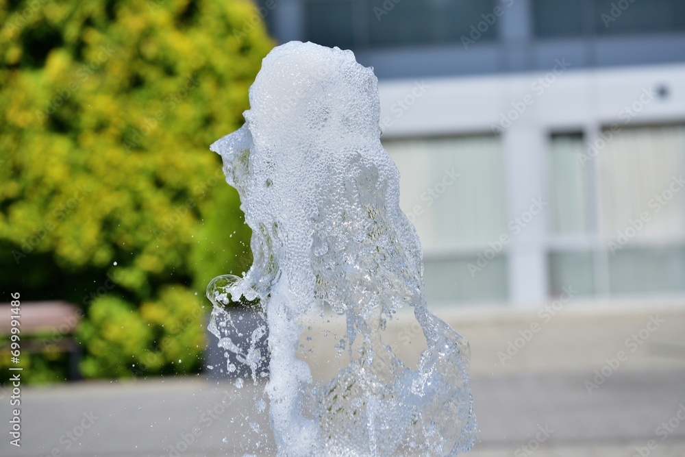 The high-flowing city fountain on the square in the city