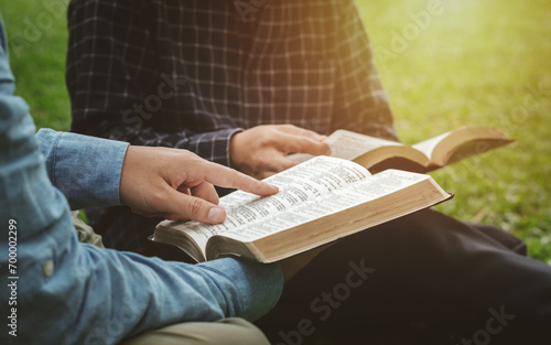 Photography Bible Study IdeasChristian Life A group of Christian friends sat at an outdoor Bible study in a park and prayed together and lived God's Word