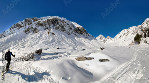 skier touring in snowy beautiful alpine mountain landscape in the French Alps...