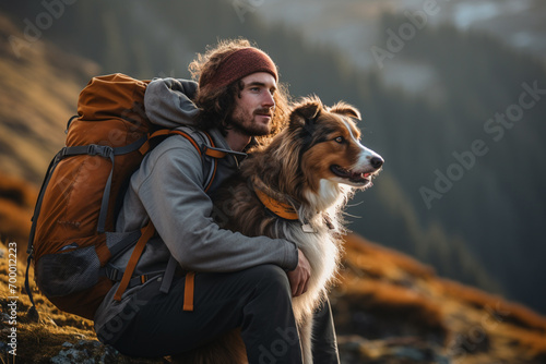 male hiker and his dog on the mountain bokeh style background