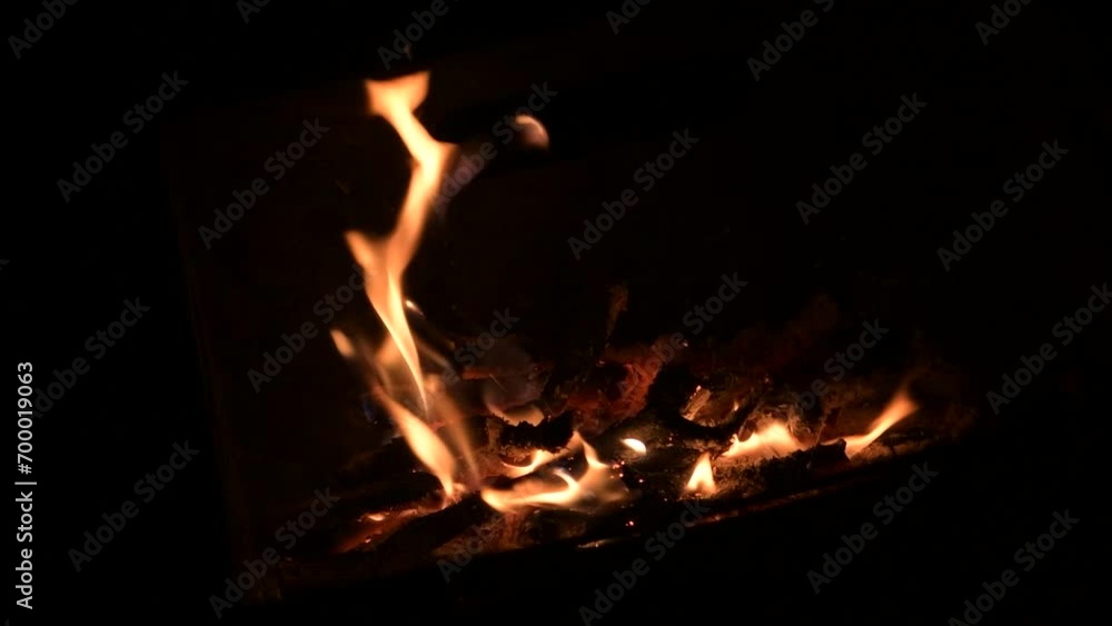 Slow motion fire flames on black background. Blazing campfire isolated on dark background. Slow motion fire flames on black background. Blazing campfire isolated on dark background.