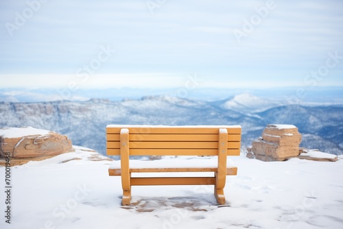 isolated bench on snowy mountain vista
