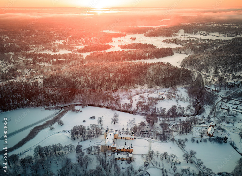 Snowy aerial winter landscape with sunset in Sweden