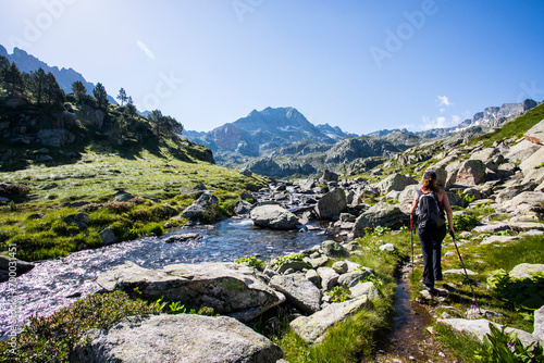 Young hiker girl summit to Ratera Peak in Aiguestortes and Sant Maurici National Park, Spain