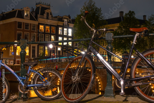 Adult and Children s Bikes on the Canal Embankment in Amsterdam at Night