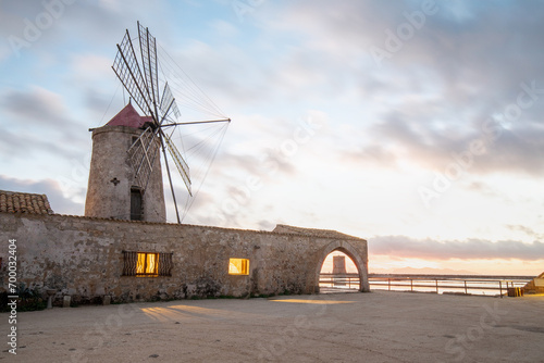 Sunset at Windmills in the salt evoporation pond in Marsala, Sicily island, Italy
Trapani salt flats and old windmill in Sicily.
View in beautifull sunny day. photo
