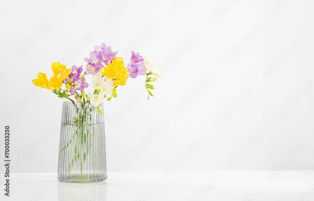 freesia flowers in glass modern vase on white background freesia flowers in glass modern vase on white background