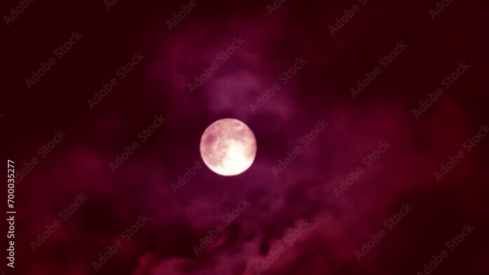 Clouds move over a red moon. Mystical horror Halloween bloody darkness background Clouds move over a red moon. Mystical horror Halloween bloody darkness background