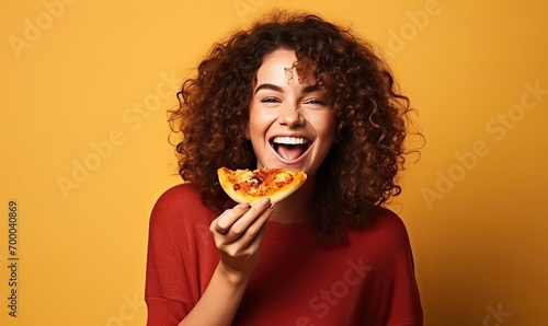 Curly-Haired Woman Enjoying a Delicious Slice of Pizza