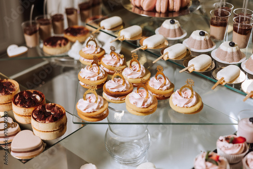 Almond cookies and various sweet cakes for a wedding banquet. A delicious reception, a luxurious ceremony. Table with sweets and desserts. Delicious colorful French desserts on a plate or table.