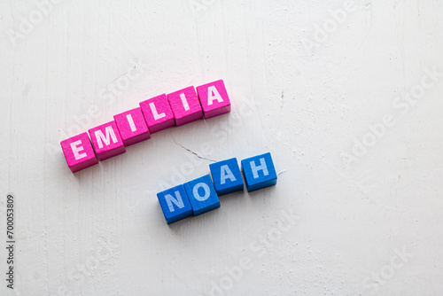 Given Names Emilia and Noah, most common in Germany 2023 placed on colorful wooden blocks on a rough wooden surface