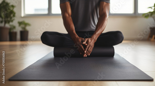 Midsection of african american man placing yoga mat