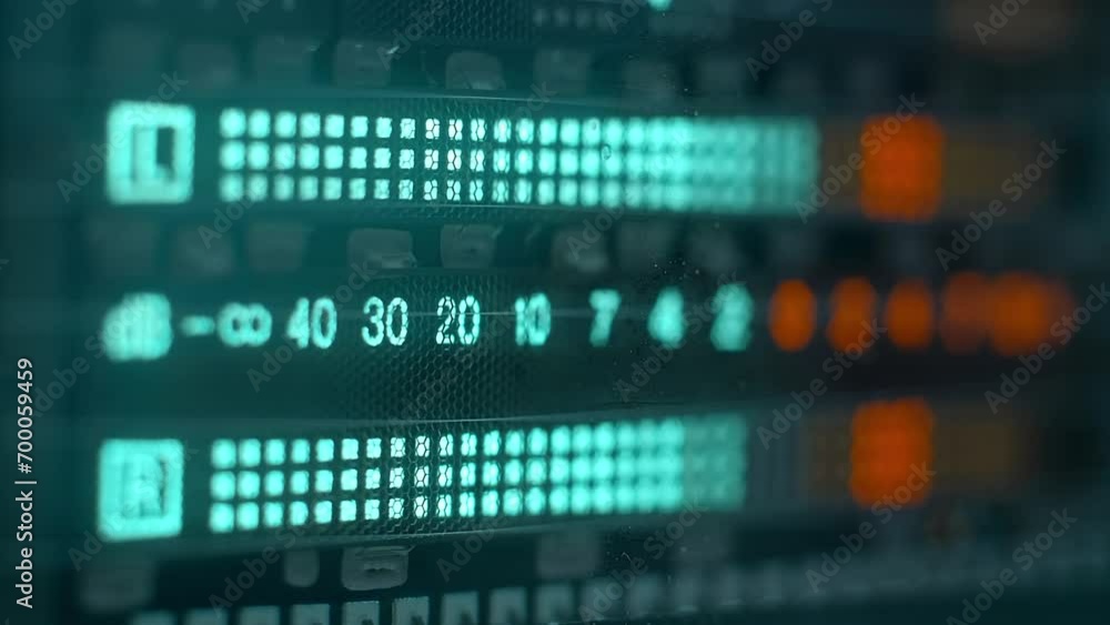 The level indicator of а music from professional recorder is glows blue and shows the decibel range and overload area with high accuracy. Closeup. Macro. Shallow depth of field The level indicator of а music from professional recorder is glows blue and shows the decibel range and overload area with high accuracy. Closeup. Macro. Shallow depth of field