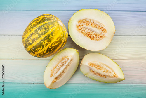 sliced melon on wood background top view