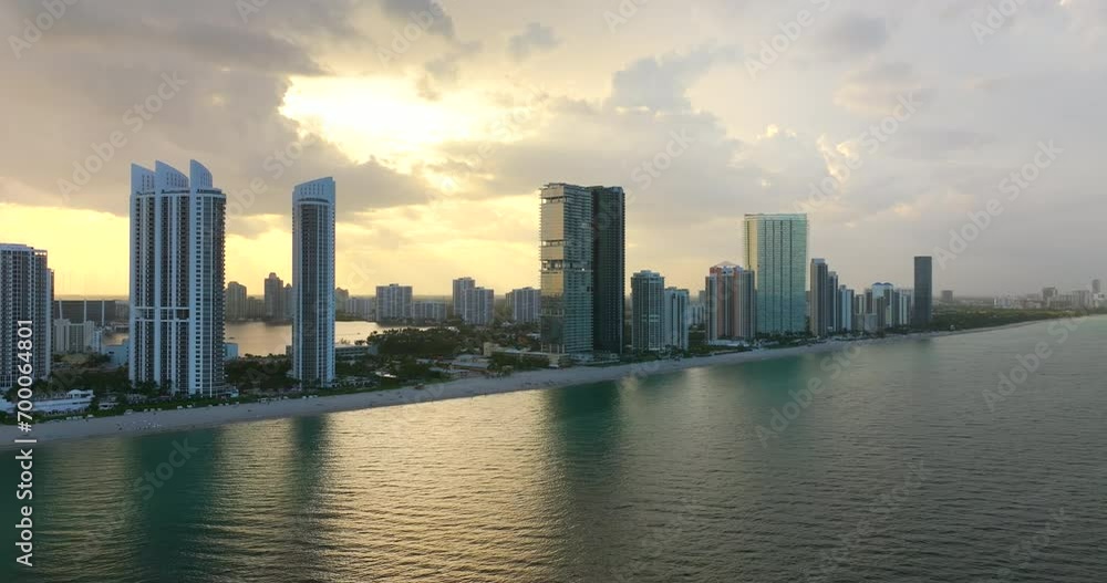 Aerial view of Sunny Isles Beach city with luxurious waterfront hotels and condos on Atlantic ocean shore. American tourism infrastructure in southern Florida