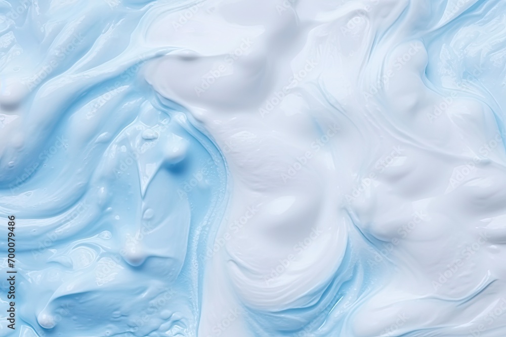 Fototapeta premium Texture background of foam. White gel for cleansing, foam for shaving, bubbles of shampoo on blue.