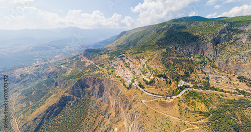 Delphi, Greece. Ruins of the ancient city of Delphi and the modern city. View of the valley. Sunny weather. Aerial view © nikitamaykov