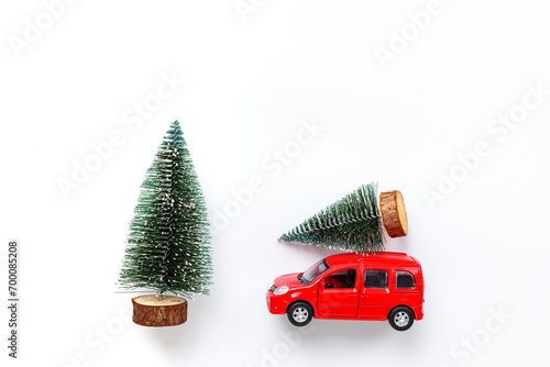 Greeting card with Christmas tree on the roof of read car toy, top view