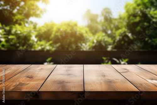 Product placement or montage featuring an empty wooden table in a sunlit summer garden with focus on the foreground table top against a white backdrop