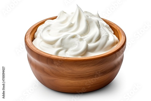 Sour cream in wooden bowl isolated on white photo