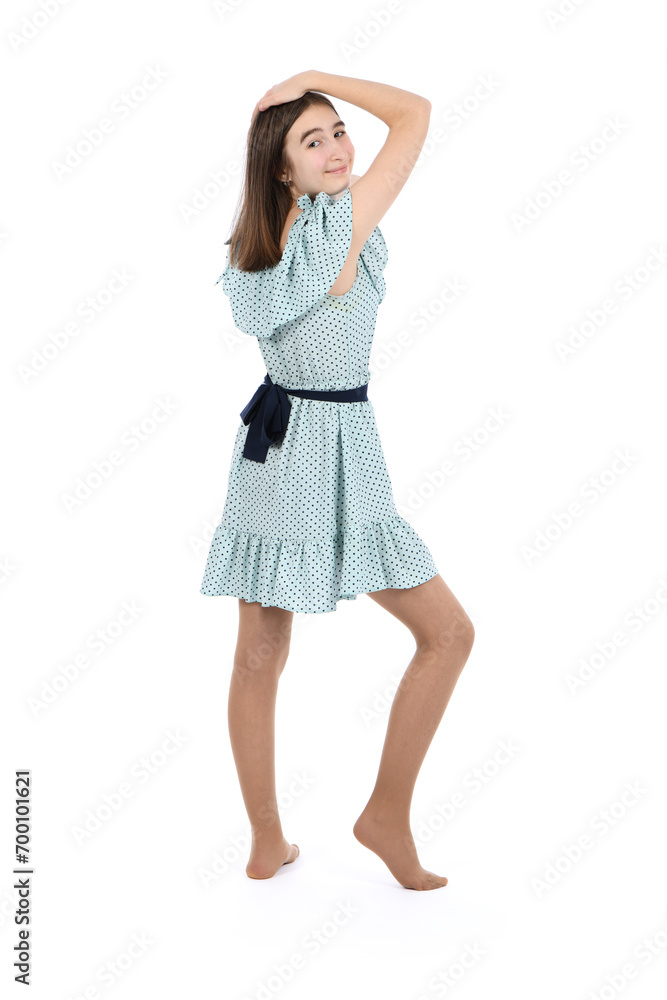 Young beautiful girl in a dress with polka dots on a white background. Young beautiful girl in a dress with polka dots on a white background.