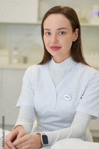 Portrait of friendly female woman beautician, aesthetic nurse or masseuse at her workplace.
