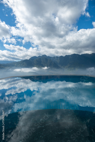 Mountain with clouds sky reflection with water in infinity pool in Sa Pa, Vietnam