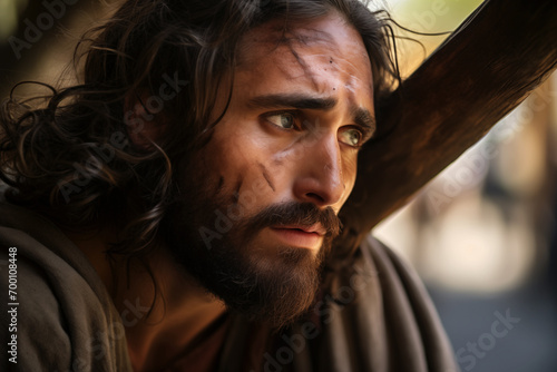 AI Generated Image of side view of sad Jesus Christ with beard and dirty face looking away while carrying wooden cross against blurred background photo