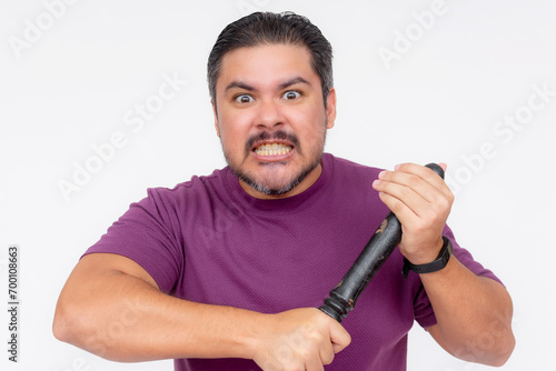 An angered man smacking a baton on his hand staring at someone menacing. Isolated on a white background.