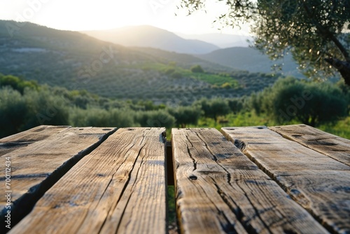 Empty old wooden table for product display with natural green olive field and green olives