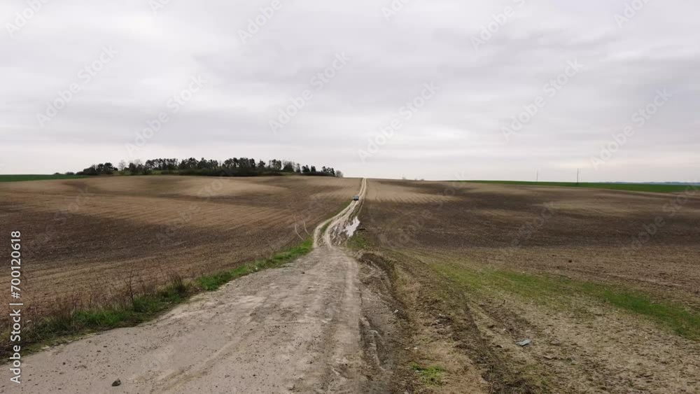 Agricultural spring landscape with cultivated fields and rolling hills Agricultural spring landscape with cultivated fields and rolling hills