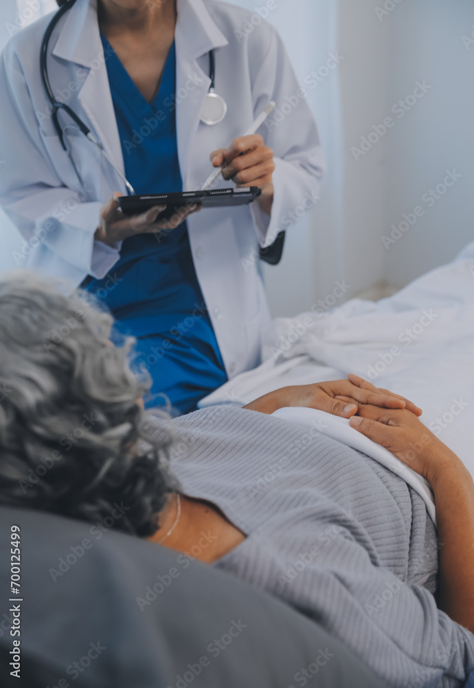 Women Asian doctors hold the patient hand and encourage and provide medical advice While checking the patient health in bed. Concept of Care and compassion, antenatal care, Threatened abortion Women Asian doctors hold the patient hand and encourage and provide medical advice While checking the patient health in bed. Concept of Care and compassion, antenatal care, Threatened abortion