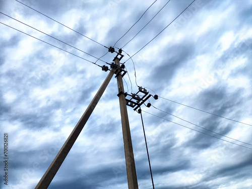 Wallpaper Mural Old power poles and the sky with clouds in the background. Electric lines, towers, wires in the landscape Torontodigital.ca