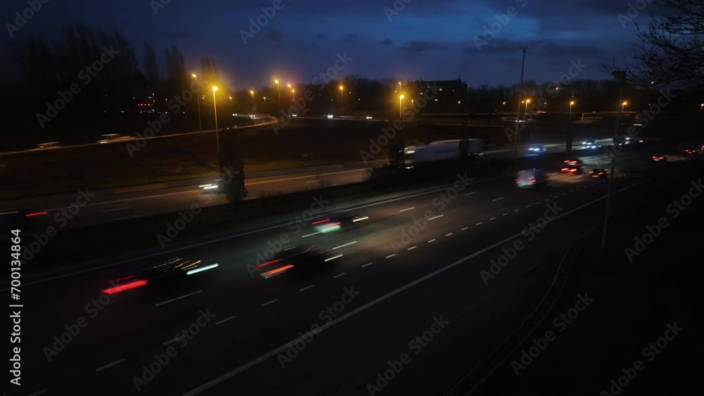 Time lapse of busy highway at dusk becoming night . Transportation, logistics, infrastructure concept . Time lapse of busy highway at dusk becoming night . Transportation, logistics, infrastructure concept .