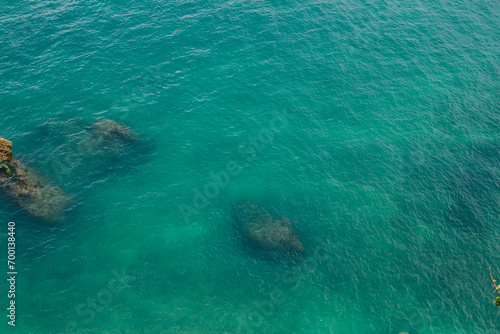 Top view of clear blue ocean waters and rocks