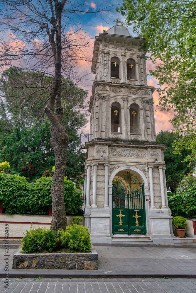 Lush green gate leads to the historic Ayios Panteleimonas Church in Kuzguncuk, Istanbul, Turkey. The church's Byzantine architecture is exquisite, and its tranquil setting offers a welcome respite